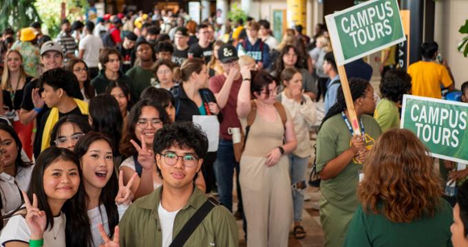 A large group of university students in a hallway.