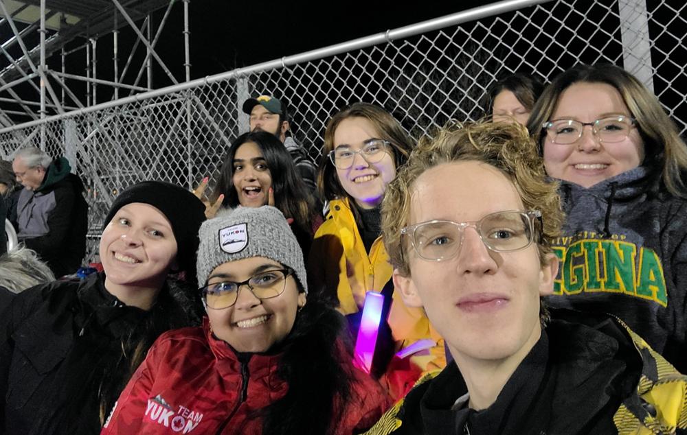 People sitting in outdoor bleachers.