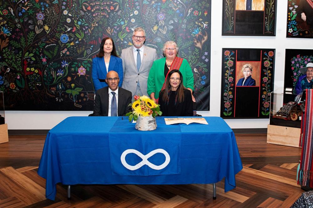 A group of individuals standing behind a table.