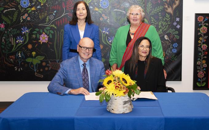 A group of individuals standing behind a table.