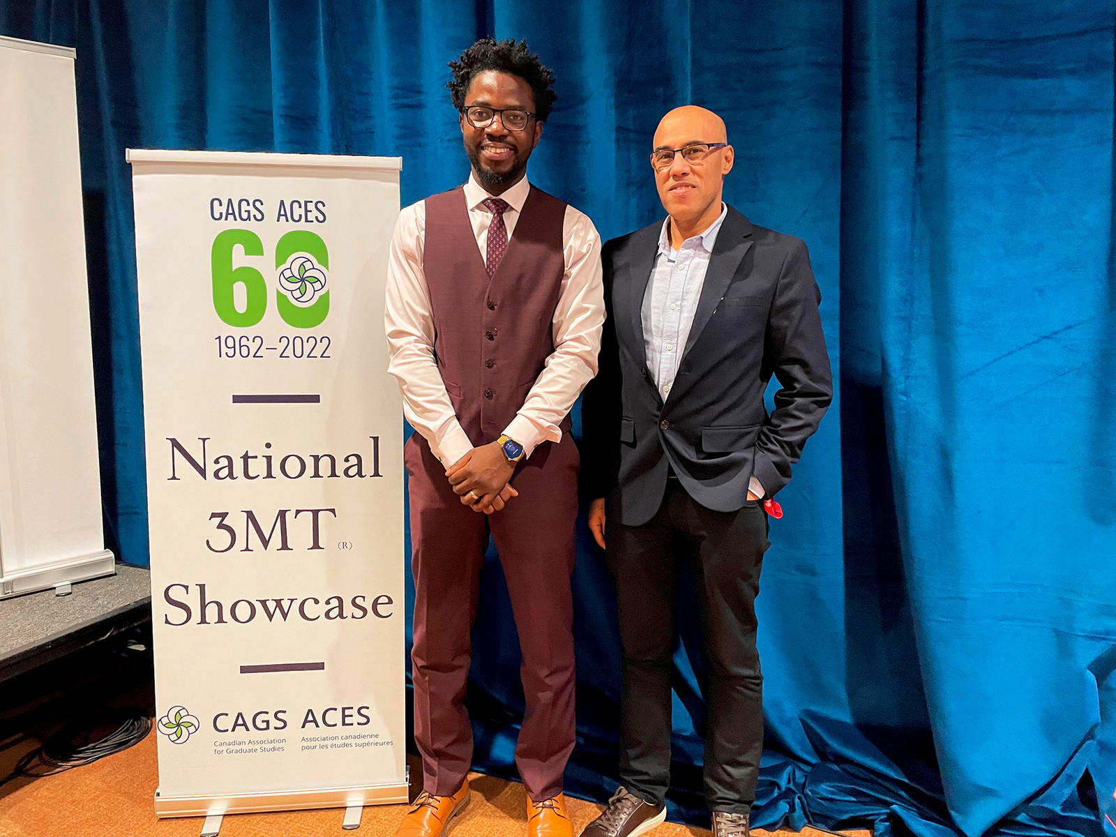 [L-R] Michael Mensah, PhD Candidate (Biology)  and Dr. Aziz Douai, Dean, Graduate Studies and Research, stand together for the first picture of Mensah as the winner of the 3MT Nationals.