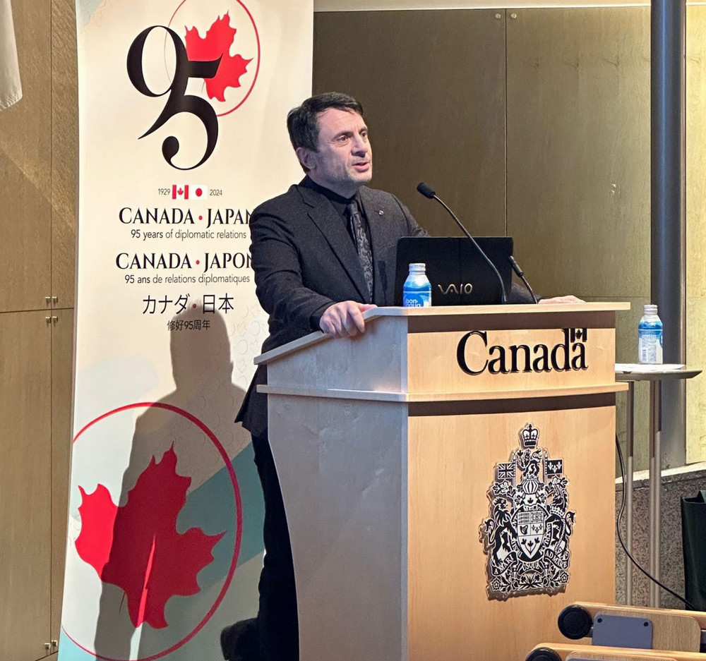 a man speaking at a podium