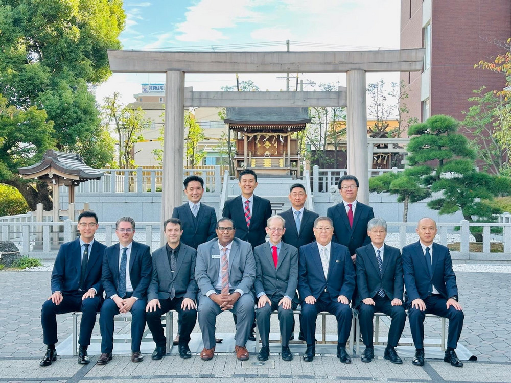 several people posing for a photo outdoors