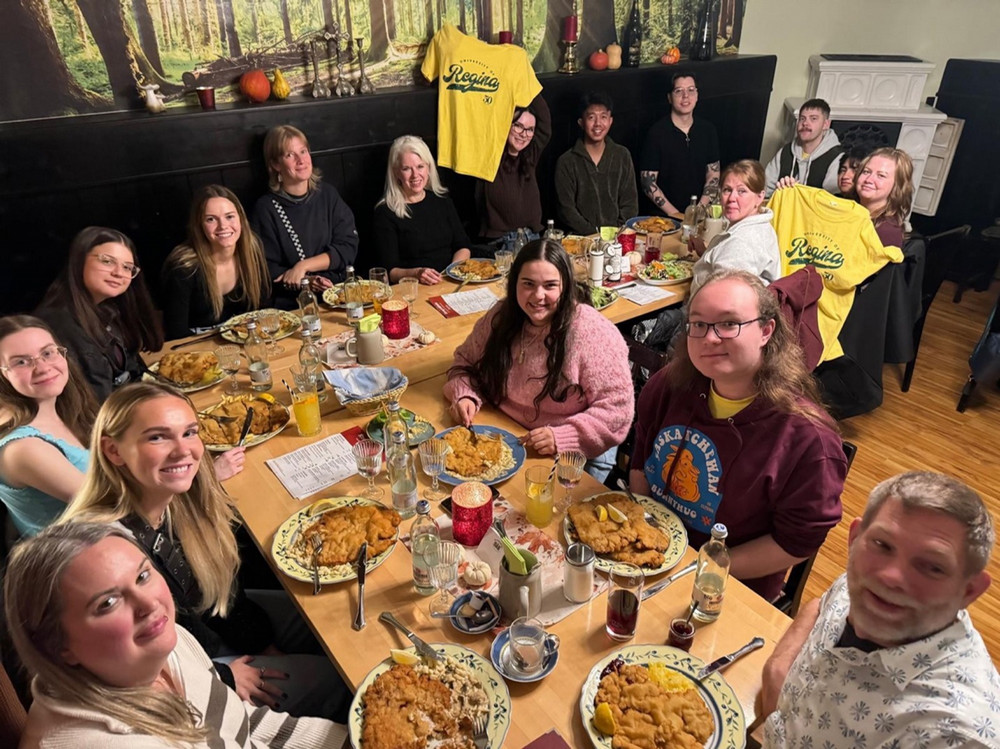 A group of individuals sitting around a table in a restaurant