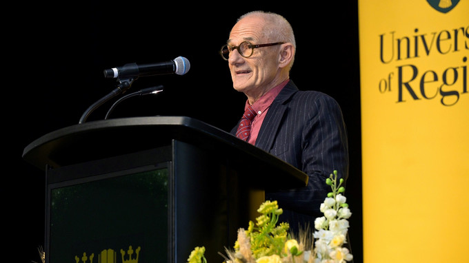 Man stands at a podium giving a lecture.