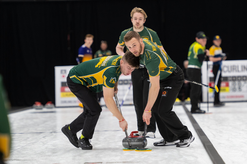 three curlers on the ice