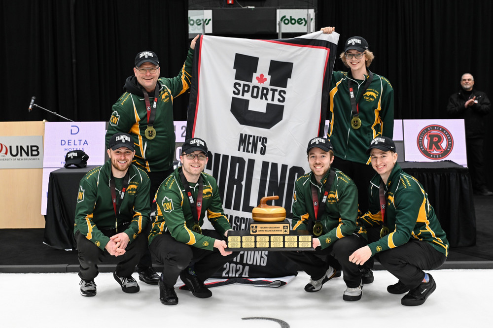 the Cougars curling team and their coaches posing