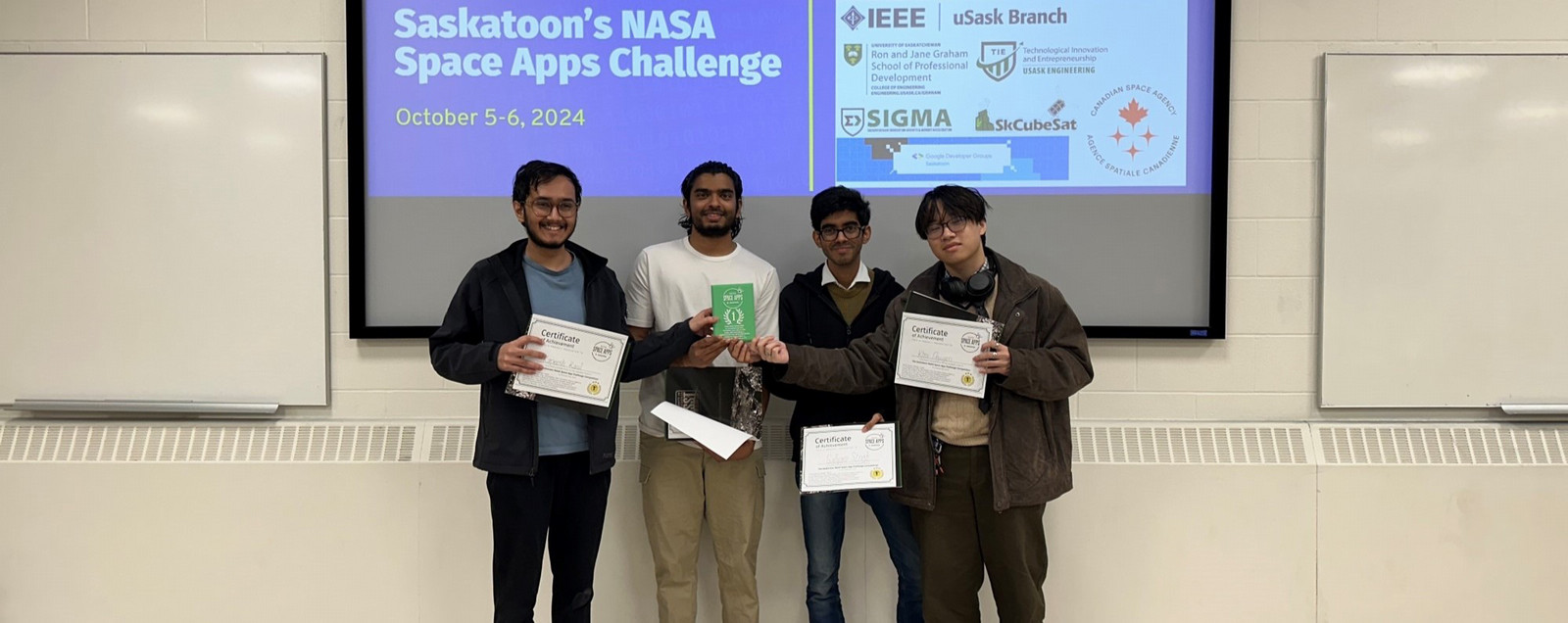 Four men holding awards