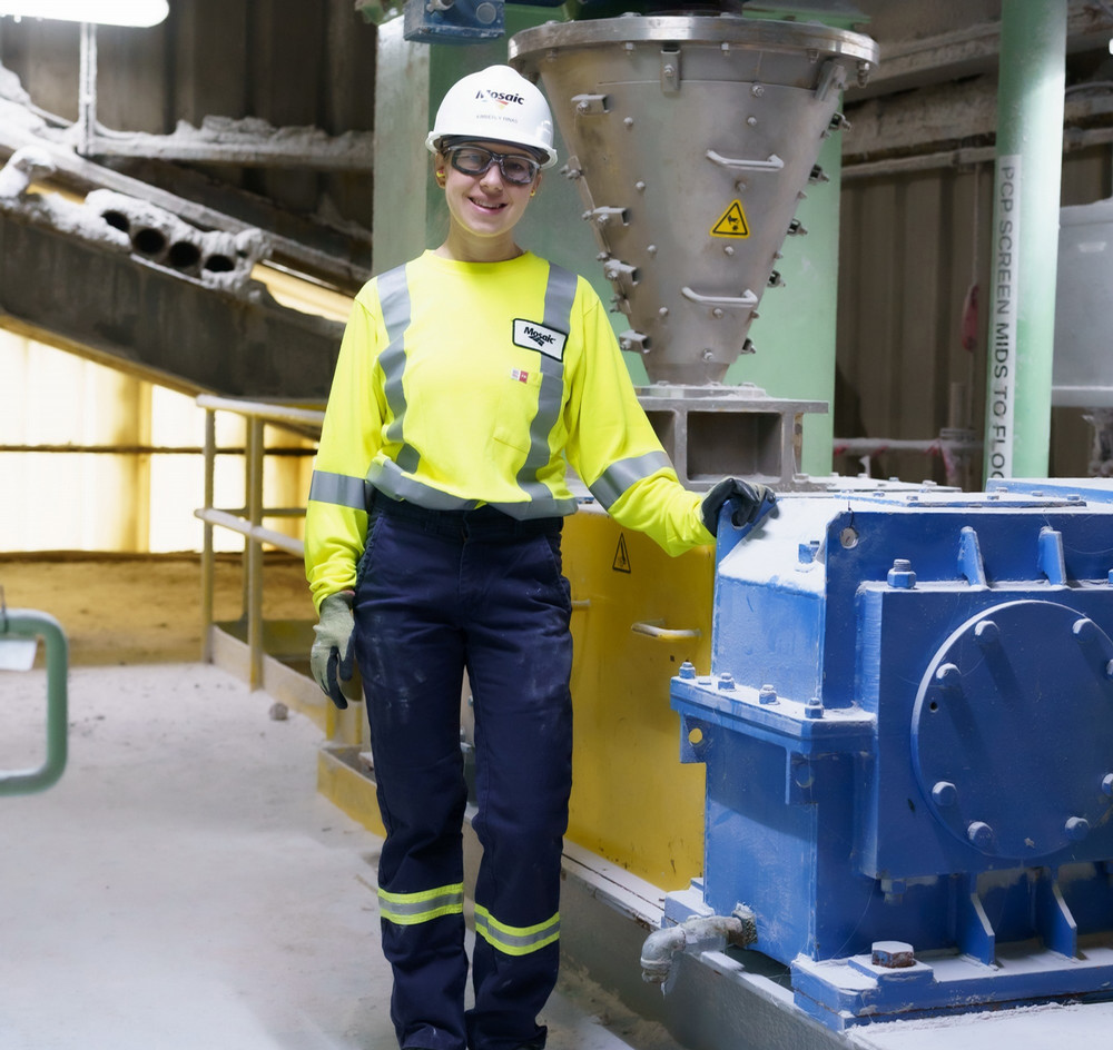 An individual dressed in personal protective equipment inside of a mine.