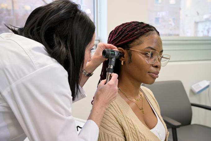 Nurse practioner examining student