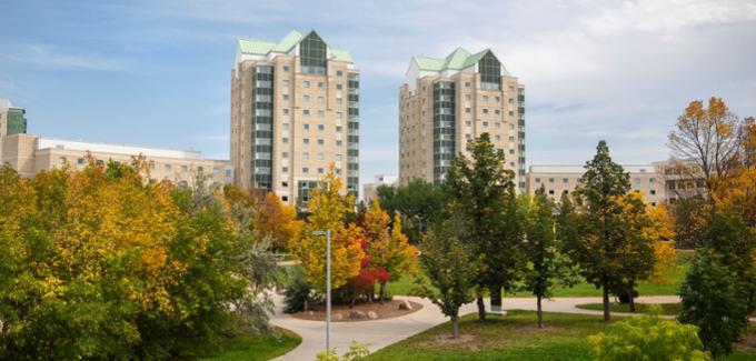 Campus towers with fall leaves.