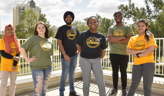 Student ambassadors smiling outside.