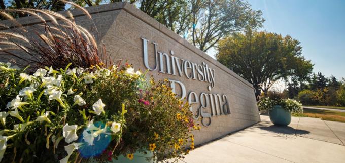 University sign with flowers.