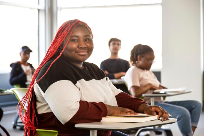 Girl sitting in classroom smiling