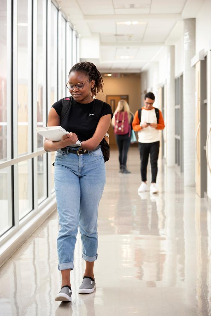 Girl walking in hallway.