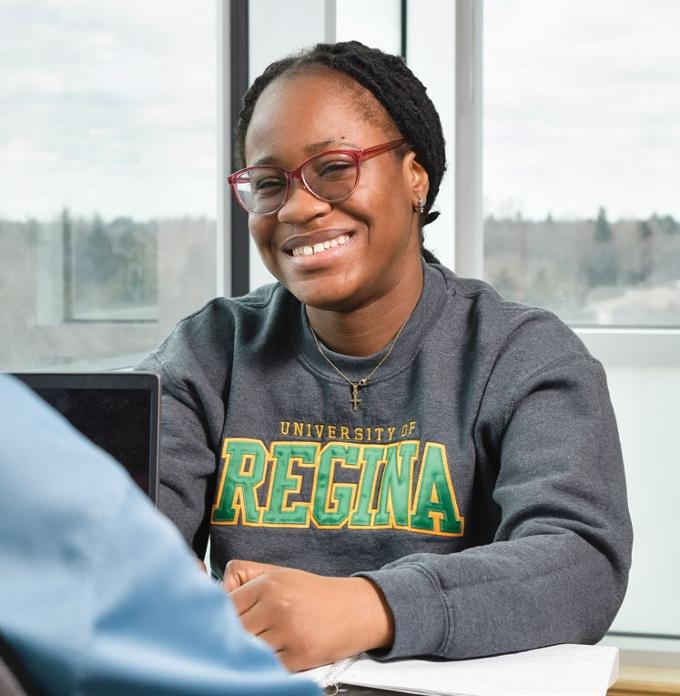 Girl smiling in classroom.