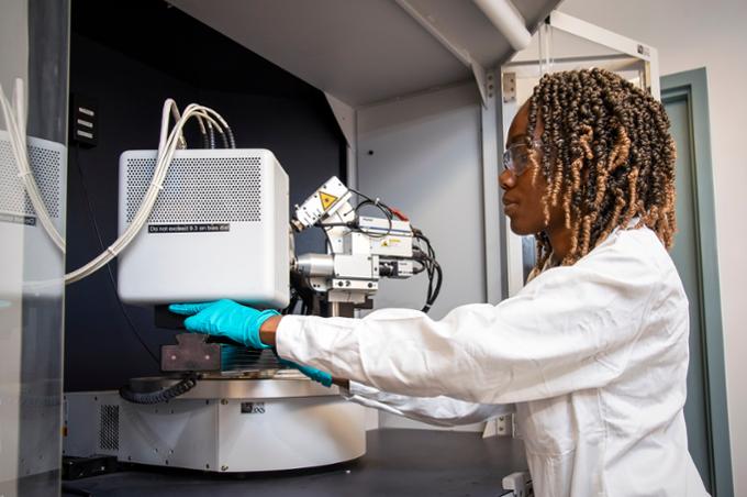 Girl operating lab equipment.