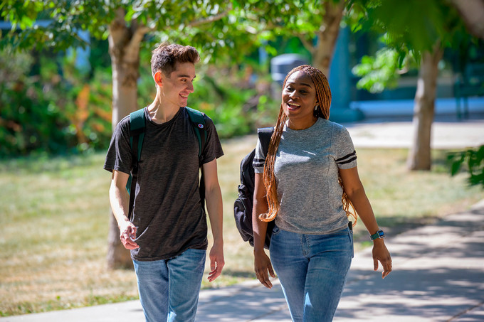 Two students walking outside.