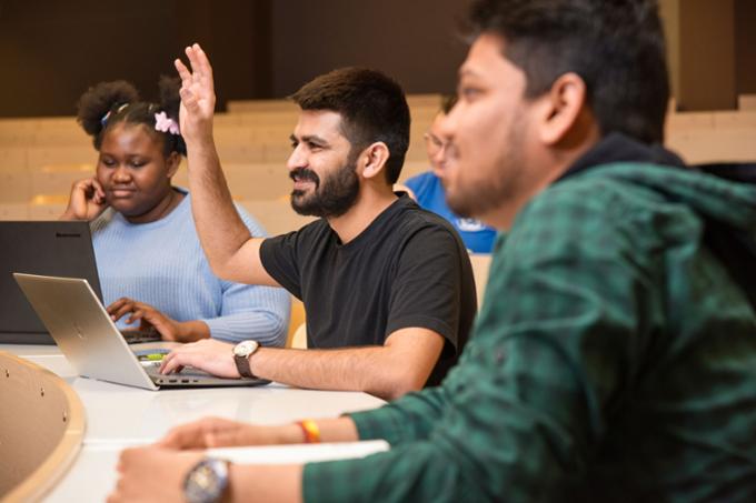 Student raising hand in class