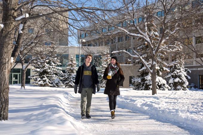 Students walking along path in winter