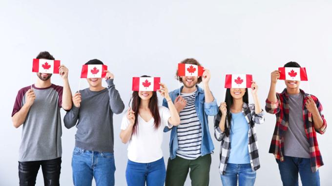 Students holding Canadian flags