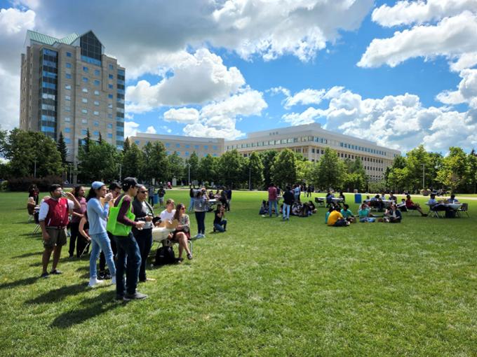 Students standing on the Academic Green