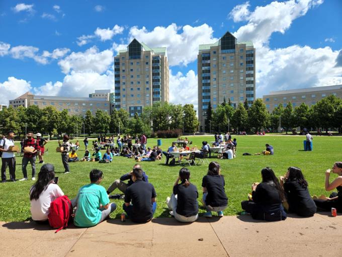 Students sitting on the Academic Green